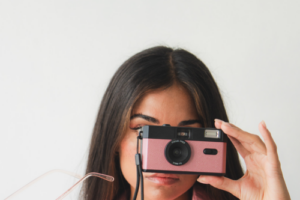 girl holding up camera