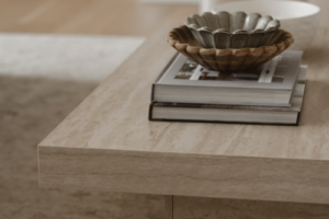 coffee table with books and bowls on it